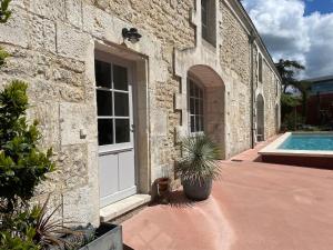 a house with a door and a swimming pool at L Atelier in Angoulême
