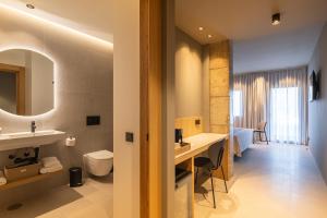 a bathroom with a sink and a toilet in a room at The Alma Suite in Alora +24 photos