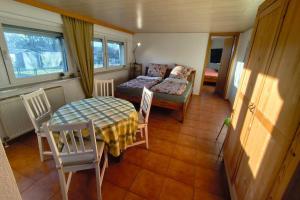 a living room with a couch and a table and chairs at A short break on Germany's largest island in Garz