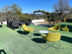 a group of chairs and tables on a lawn at Large and cozy studio in Piera