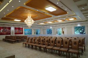 a conference room with chairs and a chandelier at Ascent Eco Resorts & Conventions in Rājānagaram +16 photos