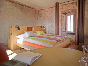 
a bedroom with a large bed and a large window at Boutique Hotel Schlossberg in Thun
