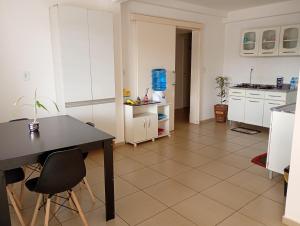 a kitchen with a table and chairs in a room at Hotel Pousada DV 360 in Dois Vizinhos