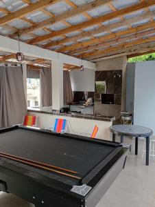 a pool table in the middle of a living room at Hotel Pousada DV 360 in Dois Vizinhos