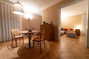 a living room with a table and chairs and a couch at Palazzo Gulino in Palma di Montechiaro