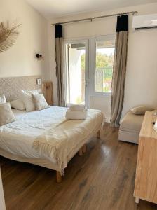 a bedroom with two beds and a window at Hôtel du Pont Blanc in Saintes-Maries-de-la-Mer +72 photos