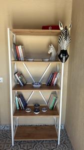 a book shelf with a zebra head and books at Pergamon Yunt Evleri in Bergama +24 photos