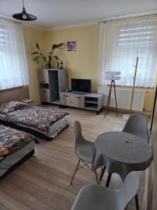 a bedroom with a bed and a table and chairs at Gościniec w Starym Młynie in Biała