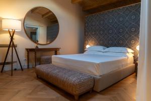 a bedroom with a large bed and a mirror at Palazzo Gulino in Palma di Montechiaro