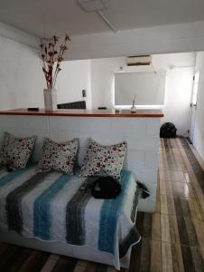 a bedroom with a bed with a cat laying on it at La soñada 1 in Villa Mercedes