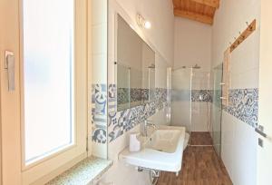 a bathroom with a sink and a mirror at Oasi Da Vinci Apartments Lake Garda View in Tignale +87 photos