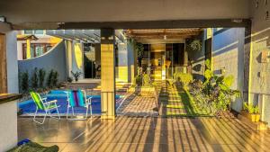 an outdoor patio with chairs and tables on a building at Hotel Pousada DV 360 in Dois Vizinhos