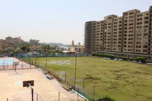a large field in a city with tall buildings at فندق النادي in Aswan
