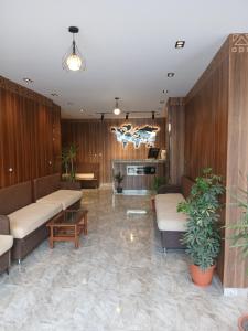 a lobby with couches and tables in a room at فندق النادي in Aswan