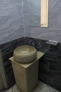 a bathroom with a wooden sink on a counter at فندق النادي in Aswan +8 photos