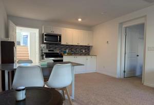 a kitchen with a table and two white chairs at Vegas courtyard B&B 拉斯小院儿民宿 in Las Vegas +10 photos