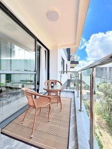 a balcony with a table and chairs and glass doors at Araka Homes-Westlands in Nairobi