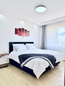 a bedroom with a large bed and a window at Araka Homes-Westlands in Nairobi +77 photos