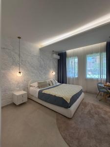 a bedroom with a large bed and a table at Suites Domus Fysi in Palermo