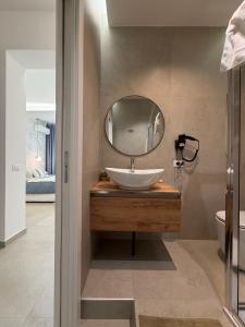 a bathroom with a sink and a mirror at Suites Domus Fysi in Palermo +103 photos