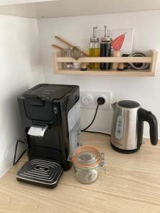a kitchen counter with a coffee maker and a toaster at Ty Moune in Crach