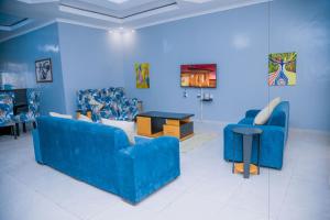 a room with two blue couches and a table at Ritha Motel Apartment in Kigali