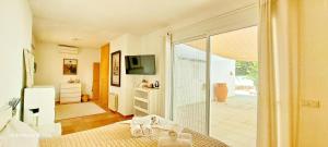a bedroom with a bed and a sliding glass door at Villa Erika by Solidays in Moraira