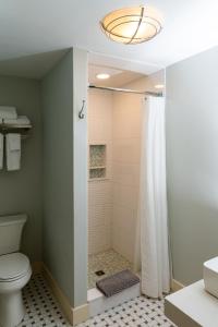 a bathroom with a shower and a toilet at The Historic General Stanton Inn in Charlestown +41 photos