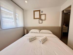 a bedroom with a large white bed with two pillows at B044 Studio moderne Croisette 100m in Cannes
