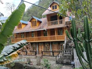 a large wooden house with a cactus in front of it at Sai Palace in Darjeeling