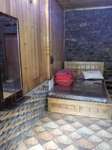 a room with a bench with luggage on it at Sai Palace in Darjeeling