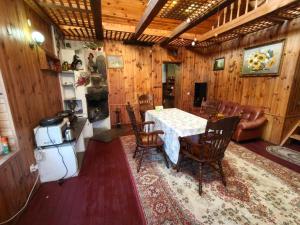 a living room with a table and chairs and a couch at Калина in Deneshi