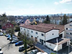 an aerial view of a town with cars parked in a parking lot at Pension La Casa in Radolfzell am Bodensee