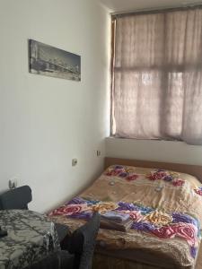 a bed in a room with a window at Apartman Stil in Kruševac