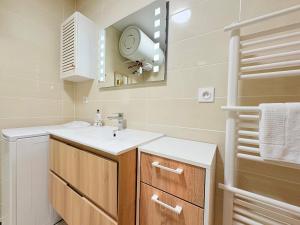 a bathroom with a sink and a mirror at L'Ariane, Vue sur le château in Foix +27 photos
