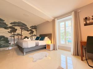 a bedroom with a bed and a large window at L'Ariane, Vue sur le château in Foix