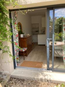 a sliding glass door leading into a kitchen at Ty Moune in Crach
