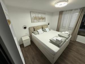 a bedroom with a bed with white sheets and pillows at Apartment Goran in Senj +58 photos