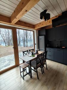a kitchen and dining room with a table and chairs at Miejscówka Werlas in Werlas