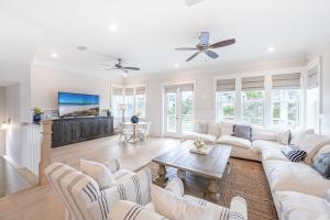 a living room with white furniture and a flat screen tv at Happily Eva After at Prominence 30A in Inlet Beach +64 photos