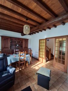 a living room with a table and a couch at Gite Familial aux portes de Foix "Le Coulhòu"- Ariège- 6 personnes in Ferrières-sur-Ariège
