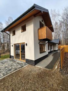a house with a balcony on top of it at Miejscówka Werlas in Werlas