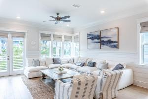 a living room with a white couch and a table at Happily Eva After at Prominence 30A in Inlet Beach