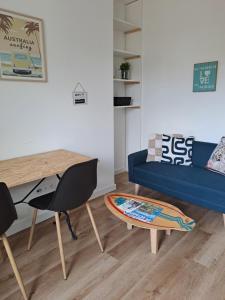 a living room with a blue couch and a table at LE 84 in Le Mans +28 photos