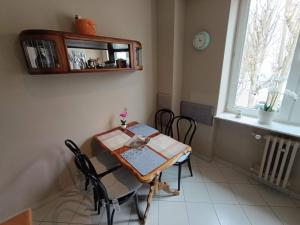 a dining room with a table and chairs and a window at Apartament 16 in Sandomierz +19 photos