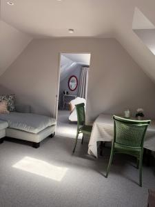 a room with a bed and a table and a mirror at The Bothy in Pewsey