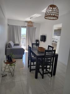 a living room with a table and chairs and a couch at Salvia in Trenque Lauquen