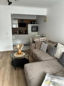 a living room with a couch and a table at Burgberg-Oase in Bad Harzburg