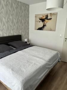 a bedroom with a bed and a painting on the wall at Burgberg-Oase in Bad Harzburg