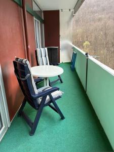 a balcony with a table and two chairs on it at Burgberg-Oase in Bad Harzburg
